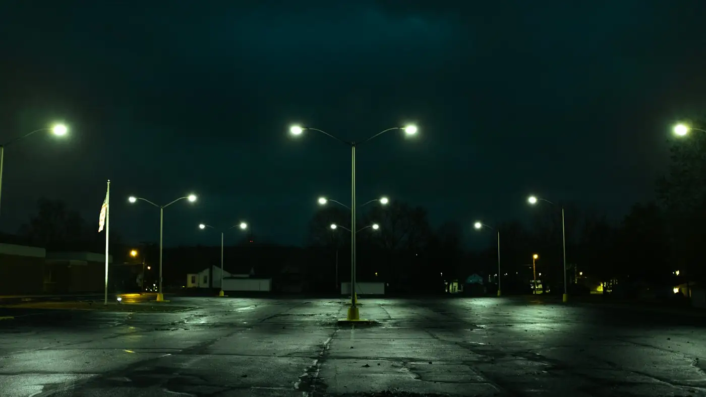 Empty parking lot under street lights at night