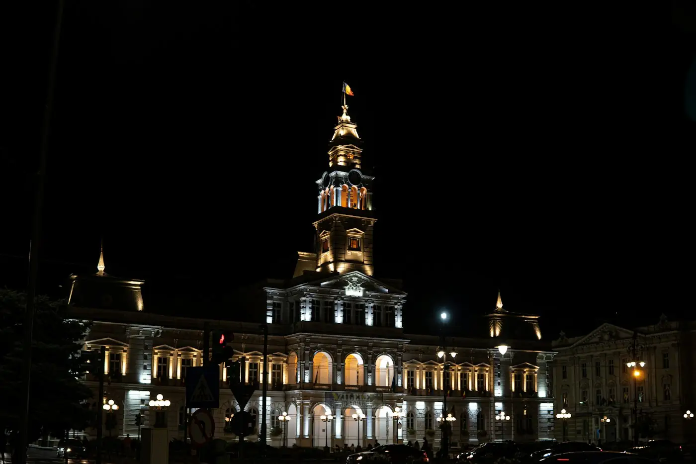 Civic building with a clock tower lit at night