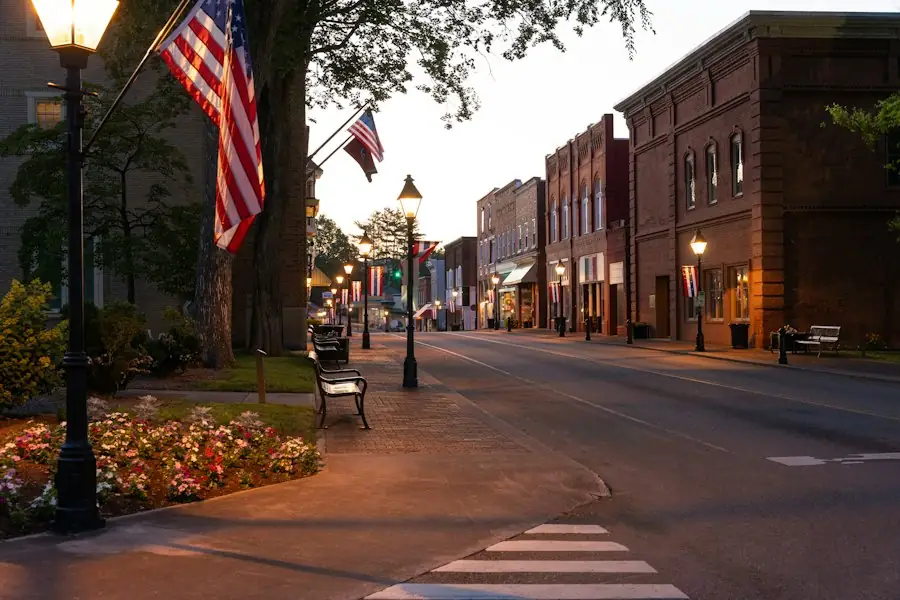 Small-town main street with American flags at dusk